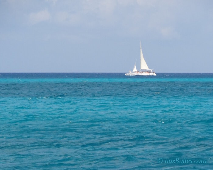 Un voilier de croisière fait route au large de la République Dominicaine sur les eaux turquoise de la mer des Caraïbes