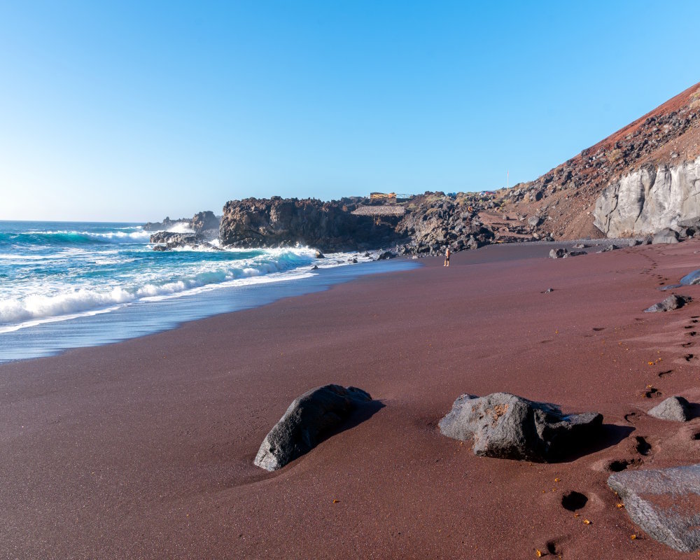 Le sable rouge volcanique intense de la plage d'El Verodal sur l'île d'El Hierro aux Canaries