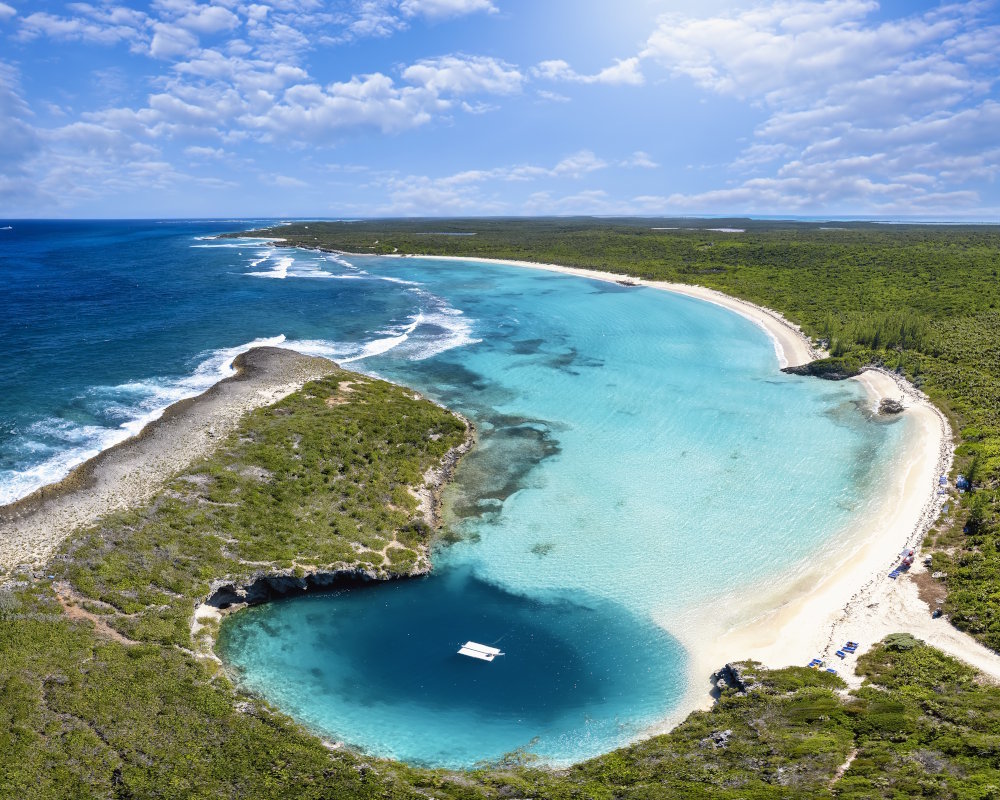 Dean's Blue Hole sur Long Island aux Bahamas, lagon naturel relié à une plage de sable blanc et à une mer turquoise.