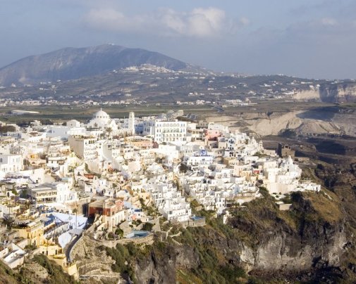 Perched atop the steep cliffs, the villages of Santorini Island gleam brilliantly white Perched atop the steep cliffs, the villages of Santorini Island gleam brilliantly white