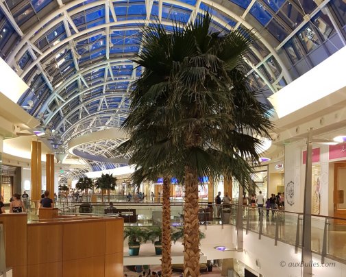 The interior of the Florida Mall with its skylight, shops and palm trees